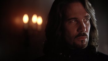 Movie still from “Darkman II: The Return of Durant” (1995), directed by Bradford May – A person with long black hair; Close Up shot, Low angle