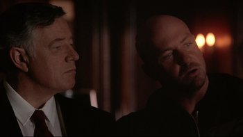 Movie still from “Darkman II: The Return of Durant” (1995), directed by Bradford May – Two men in a dark room looking at each other; Close Up shot, Over the shoulder angle