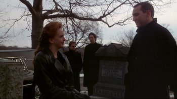 Movie still from “Darkman II: The Return of Durant” (1995), directed by Bradford May – A group of people standing next to each other near a grave; Medium shot, Over the shoulder angle