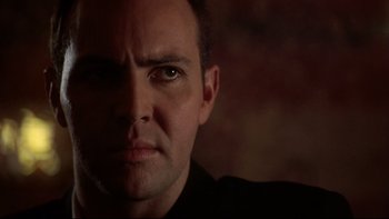 Movie still from “Darkman II: The Return of Durant” (1995), directed by Bradford May – A man's face in a dark room; Close Up shot, Low angle