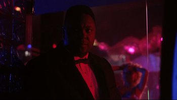 Movie still from “Darkman II: The Return of Durant” (1995), directed by Bradford May – A man in a tuxedo standing in a dark room; Close Up shot, Low angle