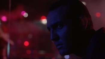 Movie still from “Darkman II: The Return of Durant” (1995), directed by Bradford May – A person's face in a dark room; Close Up shot, Low angle