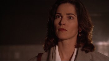 Movie still from “Darkman II: The Return of Durant” (1995), directed by Bradford May – A person with a purse; Close Up shot, Low angle