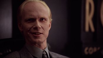 Movie still from “Darkman II: The Return of Durant” (1995), directed by Bradford May – A person wearing a suit and tie; Close Up shot, Low angle