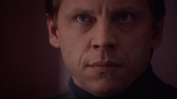 Movie still from “Darkman II: The Return of Durant” (1995), directed by Bradford May – A man's face in a dark room; Close Up shot, Low angle