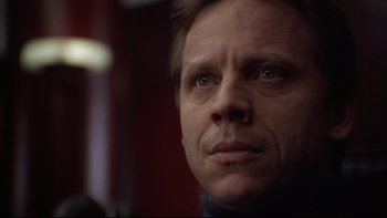 Movie still from “Darkman II: The Return of Durant” (1995), directed by Bradford May – A person looking at the camera; Close Up shot, Low angle