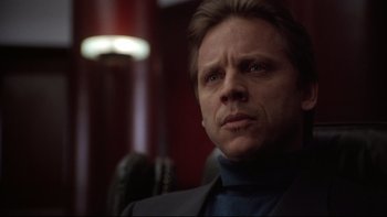 Movie still from “Darkman II: The Return of Durant” (1995), directed by Bradford May – A person wearing a suit and tie; Close Up shot, Low angle