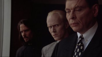 Movie still from “Darkman II: The Return of Durant” (1995), directed by Bradford May – A group of men standing next to each other in a dark room; Close Up shot, Low angle