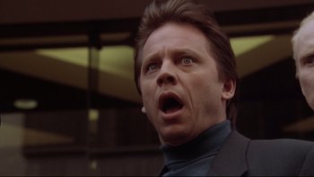 Movie still from “Darkman II: The Return of Durant” (1995), directed by Bradford May – A person with a surprised look on his face; Close Up shot, Low angle