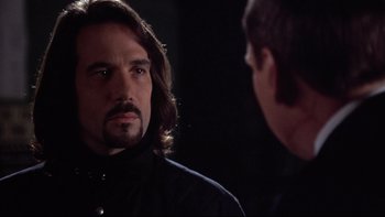 Movie still from “Darkman II: The Return of Durant” (1995), directed by Bradford May – A man with long hair is looking at himself in the mirror; Close Up shot, Over the shoulder angle