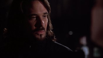 Movie still from “Darkman II: The Return of Durant” (1995), directed by Bradford May – A person with long brown hair; Close Up shot, Over the shoulder angle