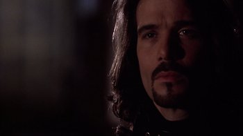 Movie still from “Darkman II: The Return of Durant” (1995), directed by Bradford May – A person with long black hair; Close Up shot, Over the shoulder angle