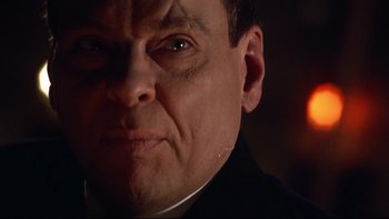 Movie still from “Darkman II: The Return of Durant” (1995), directed by Bradford May – A man's face in a dark room; Close Up shot, Low angle