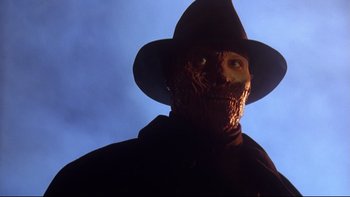 Movie still from “Darkman II: The Return of Durant” (1995), directed by Bradford May – A person wearing a mask and a hat; Close Up shot, Low angle