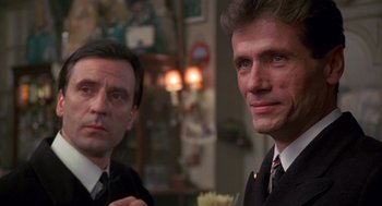 Movie still from “Das Boot” (1981), directed by Wolfgang Petersen – Two men in business suits posing for a picture; Close Up shot, Low angle