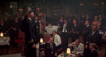 Movie still from “Das Boot” (1981), directed by Wolfgang Petersen – A group of people sitting around a room; Wide shot, Over the shoulder angle