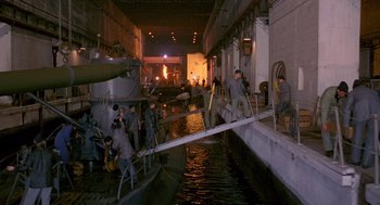 Movie still from “Das Boot” (1981), directed by Wolfgang Petersen – A group of men standing next to each other in water; Extreme Wide shot, High angle