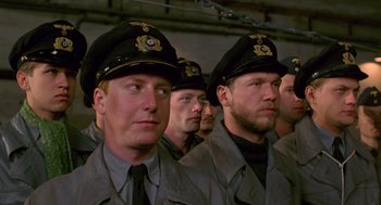Movie still from “Das Boot” (1981), directed by Wolfgang Petersen – A group of men in uniform are standing in a row; Close Up shot, Low angle