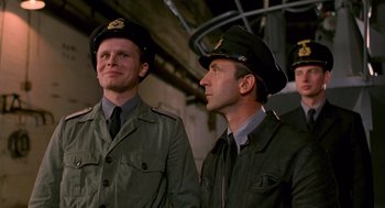 Movie still from “Das Boot” (1981), directed by Wolfgang Petersen – A couple of men standing next to each other; Medium shot, Low angle