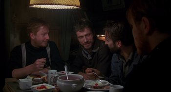 Movie still from “Das Boot” (1981), directed by Wolfgang Petersen – A group of men sitting at a dinner table; Medium shot, Low angle
