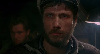 Movie still from “Das Boot” (1981), directed by Wolfgang Petersen – A person wearing a helmet; Close Up shot, Over the shoulder angle