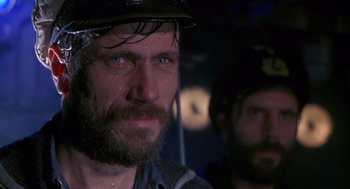Movie still from “Das Boot” (1981), directed by Wolfgang Petersen – A person wearing a hat; Close Up shot, Over the shoulder angle