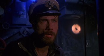 Movie still from “Das Boot” (1981), directed by Wolfgang Petersen – A man wearing a captain's hat in a ship; Close Up shot, Low angle