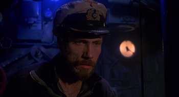 Movie still from “Das Boot” (1981), directed by Wolfgang Petersen – A man wearing a captain's hat in a ship; Close Up shot, High angle