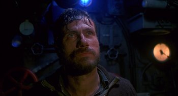 Movie still from “Das Boot” (1981), directed by Wolfgang Petersen – A man with a beard is looking into the distance; Close Up shot, Low angle