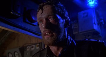 Movie still from “Das Boot” (1981), directed by Wolfgang Petersen – A person with green eyes and a beard; Close Up shot, Low angle