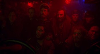 Movie still from “Das Boot” (1981), directed by Wolfgang Petersen – A group of men sitting next to each other in a dark room; Medium shot, Low angle