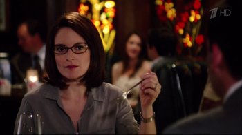 Movie still from “Date Night” (2010), directed by Shawn Levy – A woman holding a fork in her right hand while sitting at a table with other people; Close Up shot, Over the shoulder angle