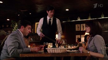 Movie still from “Date Night” (2010), directed by Shawn Levy – A man standing at a table in front of two other people; Medium shot, Over the shoulder angle