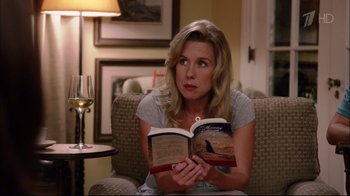 Movie still from “Date Night” (2010), directed by Shawn Levy – A woman sitting in a chair reading a book; Close Up shot, Over the shoulder angle