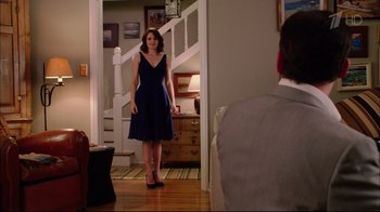 Movie still from “Date Night” (2010), directed by Shawn Levy – A woman in a blue dress standing in front of a man in a gray suit; Wide shot, Over the shoulder angle
