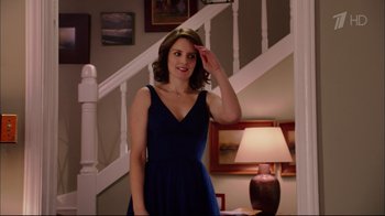 Movie still from “Date Night” (2010), directed by Shawn Levy – A beautiful young lady in a blue dress saluting in front of a lamp; Medium shot, Over the shoulder angle