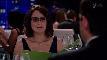 Movie still from “Date Night” (2010), directed by Shawn Levy – A woman sitting at a table with a glass of wine; Close Up shot, Over the shoulder angle