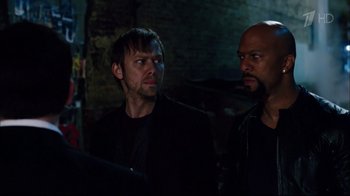 Movie still from “Date Night” (2010), directed by Shawn Levy – A man and a bald man standing next to each other; Close Up shot, Over the shoulder angle