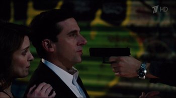 Movie still from “Date Night” (2010), directed by Shawn Levy – A man in a suit holding a gun up to his face; Close Up shot, Over the shoulder angle