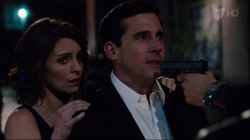 Movie still from “Date Night” (2010), directed by Shawn Levy – A man and a woman holding a gun in a dark room; Close Up shot, Over the shoulder angle