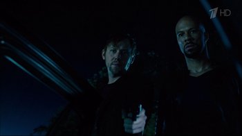 Movie still from “Date Night” (2010), directed by Shawn Levy – Two men standing next to each other in the dark; Medium shot, Low angle