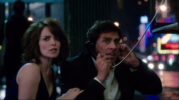 Movie still from “Date Night” (2010), directed by Shawn Levy – A man and a woman are talking on a phone; Medium shot, Over the shoulder angle