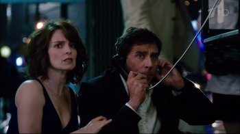 Movie still from “Date Night” (2010), directed by Shawn Levy – A man and a woman are talking on a phone; Medium shot, Over the shoulder angle