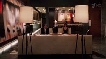 Movie still from “Date Night” (2010), directed by Shawn Levy – A group of people sitting on top of a white couch; Wide shot, Over the shoulder angle