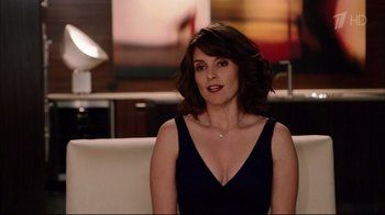 Movie still from “Date Night” (2010), directed by Shawn Levy – A woman sitting on top of a couch in a living room; Medium shot, Over the shoulder angle