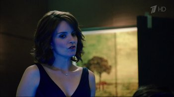 Movie still from “Date Night” (2010), directed by Shawn Levy – A beautiful woman in a black dress standing in front of a painting; Close Up shot, Over the shoulder angle