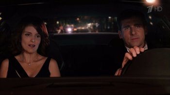 Movie still from “Date Night” (2010), directed by Shawn Levy – A man and a woman sitting in the back of a car; Medium shot, Over the shoulder angle