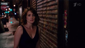 Movie still from “Date Night” (2010), directed by Shawn Levy – A woman standing in front of a wall of dvd's; Close Up shot, Over the shoulder angle
