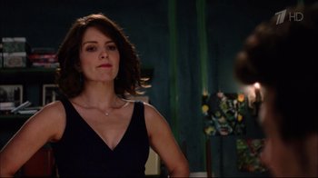 Movie still from “Date Night” (2010), directed by Shawn Levy – A woman in a black dress looking at a mirror; Medium shot, Over the shoulder angle