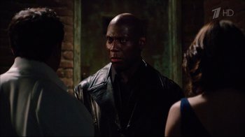 Movie still from “Date Night” (2010), directed by Shawn Levy – A man in a leather jacket standing next to two other people; Medium shot, Over the shoulder angle